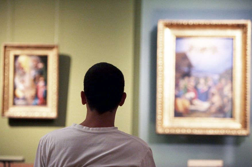 A visitor views paintings at the Museum of Fine Arts in Budapest. There are uncounted works of art housed in museums in Eastern Europe for which there are no reliable records of how the museums came to ownership during World War II and immediately thereafter. (Associated Press)