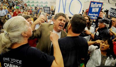 The Washington Times
Pro-lifer Randall Terry, founder of Operation Rescue, gets into a shouting match over health care legislation at an August 2009 town-hall meeting held by Rep. James P. Moran, Virginia Democrat, in Reston, Va. A year later, both sides are still shouting.