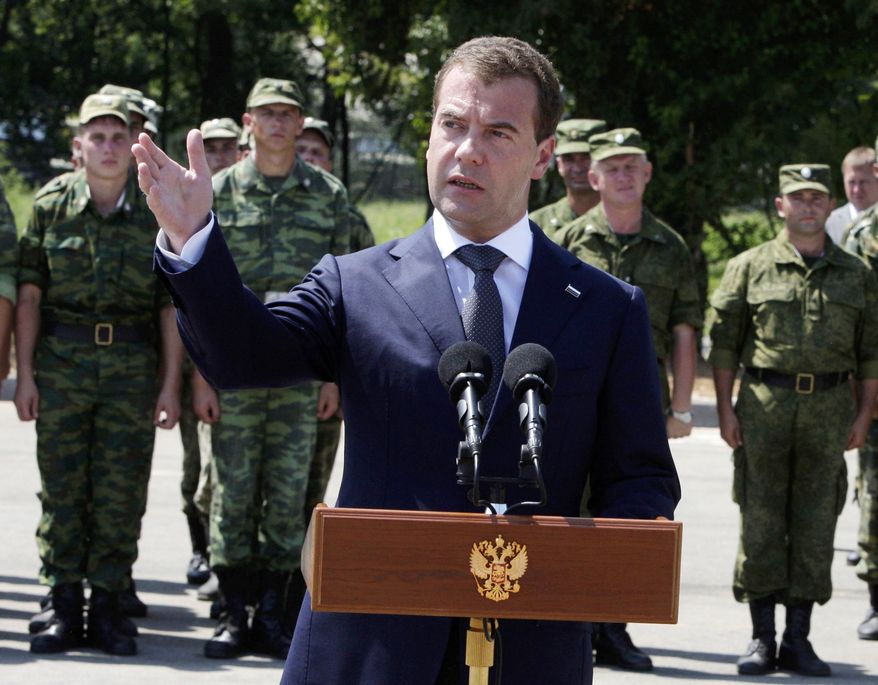 Russian President Dmitry Medvedev speaks to Russian troops stationed at the key Black Sea port of Gudauta in Abkhazia. Mr. Medvedev pledged Sunday to provide further support to breakaway Georgian regions on the anniversary of the Russian-Georgian war. He arrived in Abkhazia to hold talks with the Kremlin-friendly separatist government. (Associated Press)