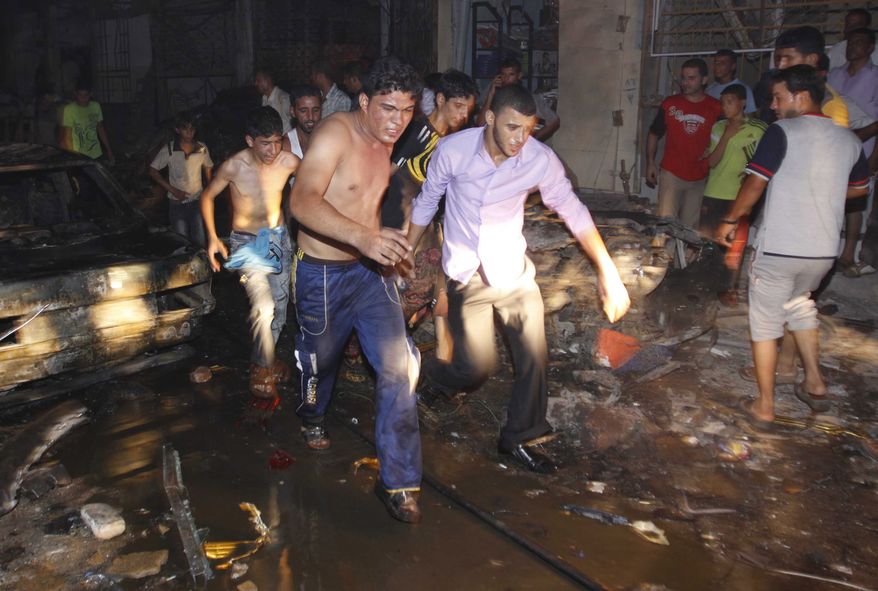 Iraqis evacuate a victim from the scene of an explosion in Basra, Iraq's second-largest city, 340 miles southeast of Baghdad, on Saturday, Aug. 7, 2010. (AP Photo/Nabil al-Jurani)