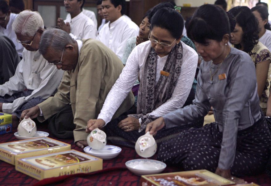 Former student activists and pro-democracy politicians hold a quiet religious ceremony at a Buddhist monastery in an eastern suburb of Yangon, Myanmar, on Sunday, Aug. 8, 2010, to mark the anniversary of the 1988 uprising that was brutally crushed by Myanmar's military. More than a million people rose up Aug. 8 that year to protest an entrenched military-backed regime headed by Gen. Ne Win that had wiped out the savings of many by a sudden demonetization of the currency. (AP Photo/Khin Maung Win)