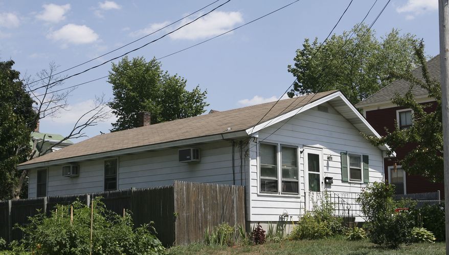 Beatrice Munyenyezi, 40, bought this three-bedroom house on Howe Street in Manchester, N.H., in 2003 for $190,000. Federal prosecutors say Mrs. Munyenyezi directed kidnapping, rape and murder during the genocide in Rwanda in 1998. (AP Photo/Jim Cole)