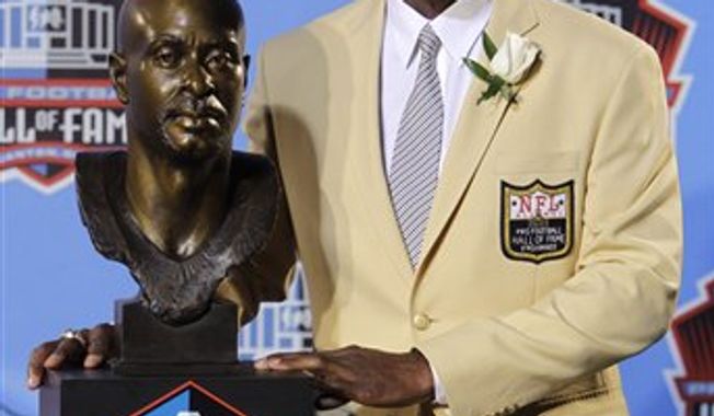 Former San Francisco 49ers great Jerry Rice poses with his bust after enshrinement in the Pro Football Hall of Fame in Canton, Ohio Saturday, Aug. 7, 2010. (AP Photo/Mark Duncan)