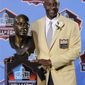 Former San Francisco 49ers great Jerry Rice poses with his bust after enshrinement in the Pro Football Hall of Fame in Canton, Ohio Saturday, Aug. 7, 2010. (AP Photo/Mark Duncan)