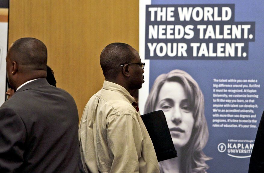 Francis Didier (right) of Miami stands in line to see representatives from Kaplan University at a job fair sponsored by National Career Fairs in Dania Beach, Fla. (AP Photo/Lynne Sladky)