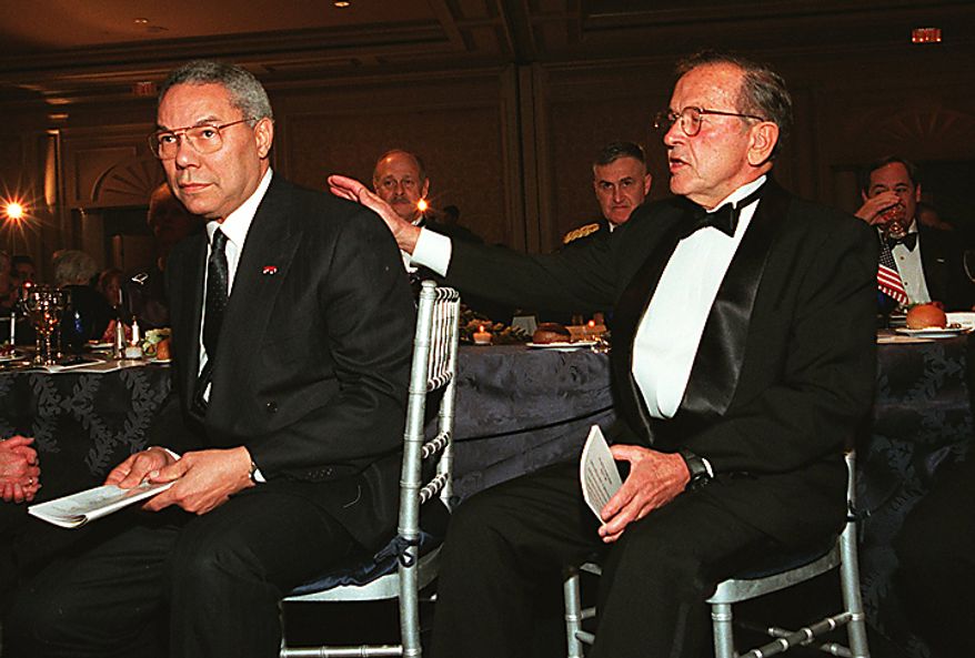 Alaska Senator Ted Stevens (right), one of this year's USO honorees, gives a pat on the back to his good friend, former chairman of the Joint Chiefs of Staff Gen. (ret.) Colin Powell (left), March 29, 2000. Behind them can be seen actor Gerals McRaney and the current chairman of the Joint Chiefs, Gen. Richard Shelton. ( James R. Brantley / The Washington Times )