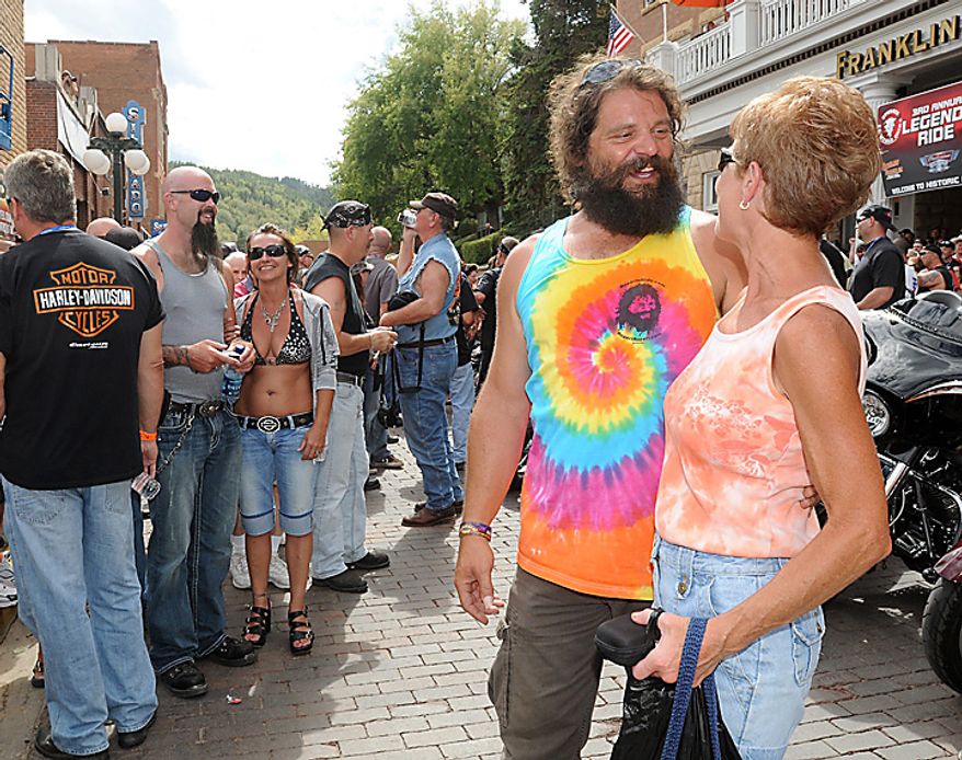Rupert Boneham, a favorite on the reality TV series "Survivor," chats with friends and poses for photos on Main Street in Deadwood, S.D. on Monday, Aug. 9, 2010 before rolling out on the 3rd Annual Legends Ride charity event, which is part of the 70th Annnual Sturgis Motorcycle Rally. (AP Photo/Steve McEnroe)