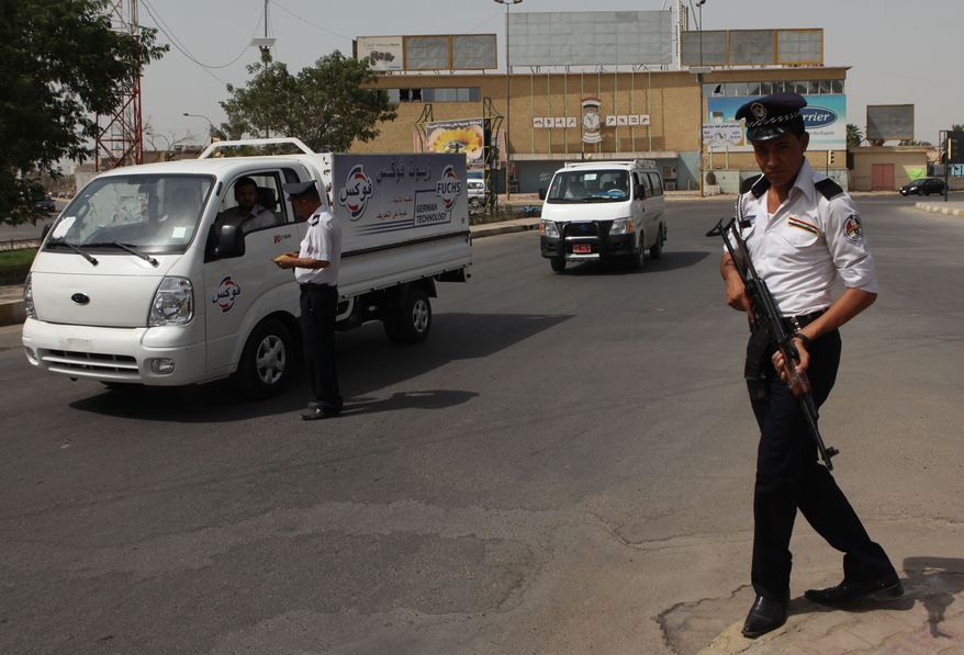 An Iraqi traffic policeman works during a sunny day on which the temperature reached 116 degrees Fahrenheit in the Azamiyah neighborhood of Baghdad on Wednesday, Aug. 11, 2010. Muslims throughout the world are observing Ramadan, the holiest month in the Islamic calendar, during which they refrain from eating, drinking, smoking and having sexual relations from sunrise to sunset. (AP Photo/Khalid Mohammed)