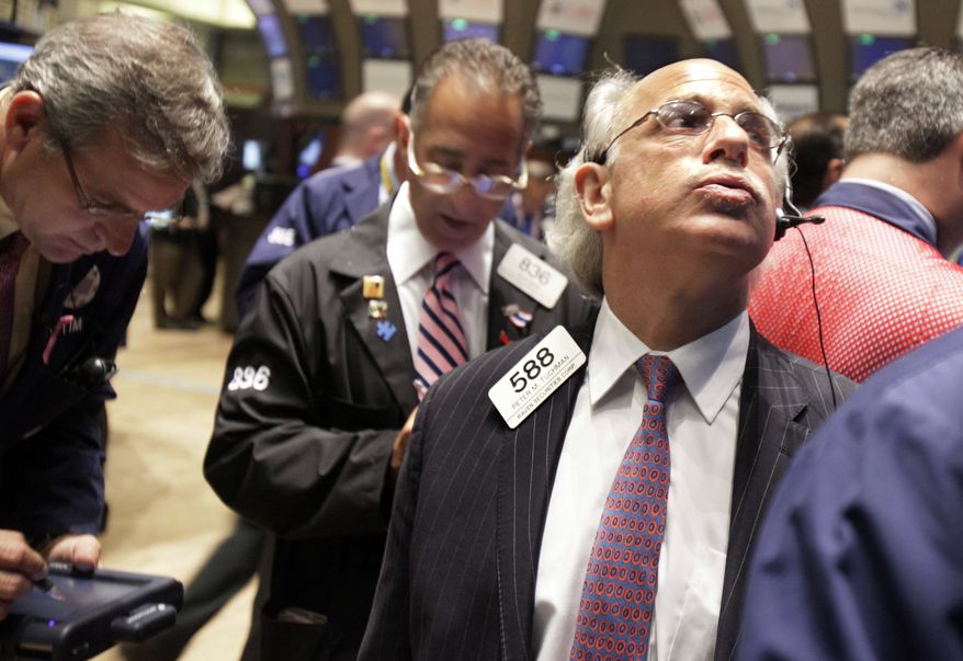 Trader Peter Tuchman (right) watches the numbers as he works on the floor of the New York Stock Exchange on Tuesday, Aug. 10, 2010. (AP Photo/Richard Drew)
