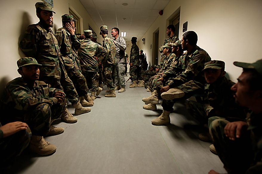 In this Saturday, Aug. 7, 2010 photo, U.S Air Force Mentor-CRNA Maj. David Johnson, center, of the Medical Training Advisory Group, or MTAG, helps manage dozens of Afghan army cadets he convinced to participate in a blood drive, at Kandahar Regional Military Hospital, KRMH, inside Camp Hero, Kandahar province, southern Afghanistan. The MTAG team, comprised of 12 U.S. Air Force medical professionals, is assigned to the Afghan military hospital, and are tasked with providing transitional guidance to local medical workers, who treat Afghan soldiers, civilians, and occasionally insurgents. (AP Photo/Brennan Linsley)