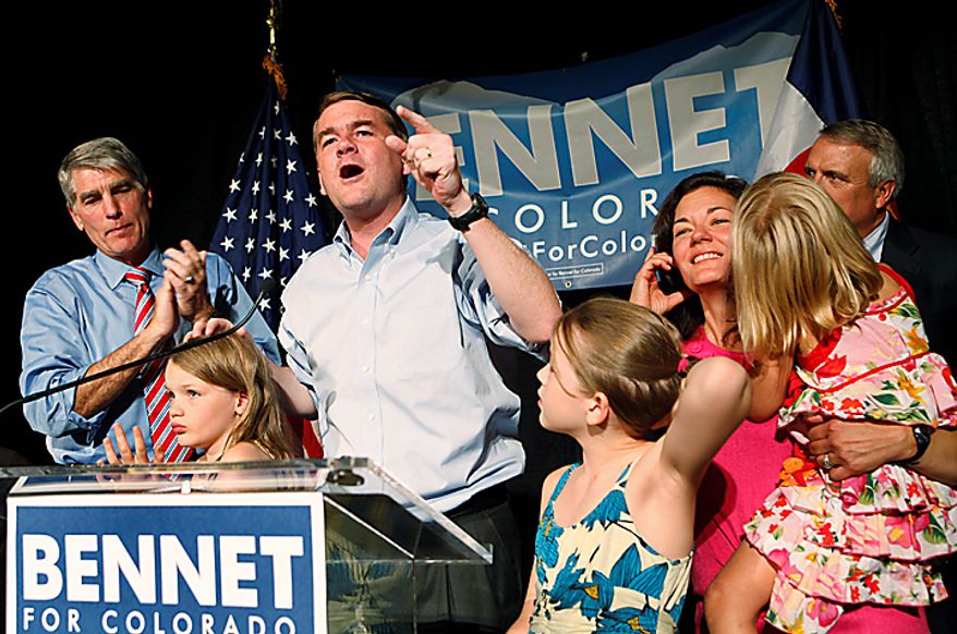 Sen. Michael Bennet, center, D-Colo., celebrates after winning the Democratic primary on Tuesday, Aug. 10, 2010, in Denver. He was joined on stage by his wife, third right, children, Senator Mark Udall, left, and Gov. Bill Ritter, back right. (AP Photo/Ed Andrieski)