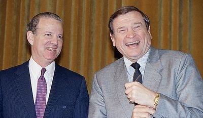 Treasury Secretary James Baker III, left, shares a light moment with House Ways and Means Committee Chairman Dan Rostenkowski of Illinois on Capitol Hill in Washington, Tuesday, Feb. 10, 1987. Baker told the committee that the U.S. trade deficit appears to be leveling off under pressure from a declining dollar and indicated that further falls in the dollar against the Japanese yen may not be desirable. (AP Photo/John Duricka)
