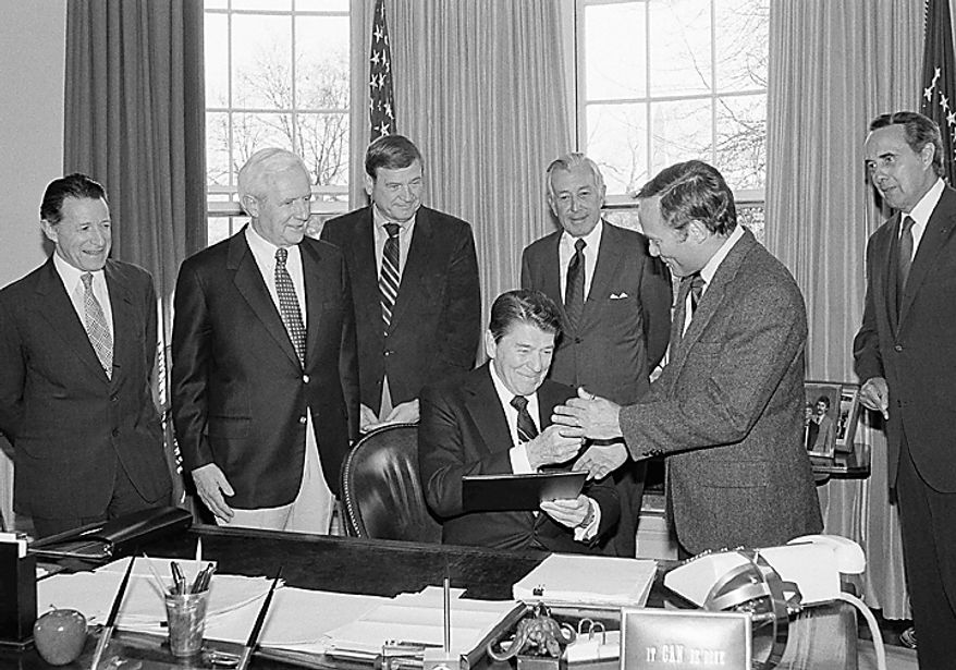 U.S. President Ronald Reagan gives a pen to Rep. W. R. Archer, R-Texas, after signing H.R. 4206, Tuesday, April 10, 1984 in Washington at the White House. The bill amends the Internal Revenue Service code of 1954 to exempt from federal taxes of military employees of the U.S. who have died overseas. With the President from left, Defense Secretary Caspar Weinberger, Sen. Roger Jepsen, R-Iowa, Rep. Dan Rostenkowski, D-Ill., Treasury Secretary Donald Regan and Archer. (AP Photo/Barry Thumma)
