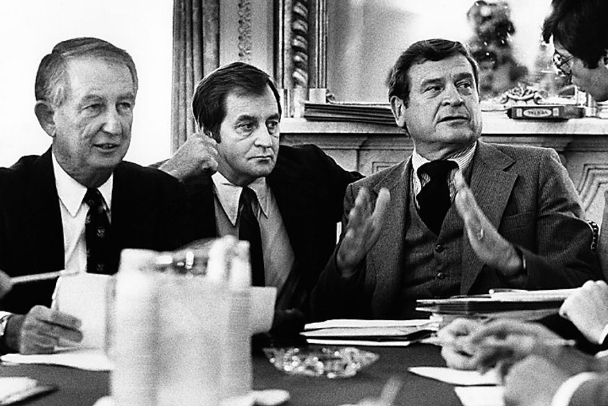 Democratic members of the House Ways and Means Committee meet at Capitol Hill in Washington where it was indicated that they would support a two-year tax cut plan in opposition to the three-year one offered by the Reagan administration, June 3, 1981. From left are panel members Sam Gibbons of Fla. and chairman of the panel Dan Rostenkowski of Ill. Men in center and right are unidentified aides. (AP Photo/John Duricka)