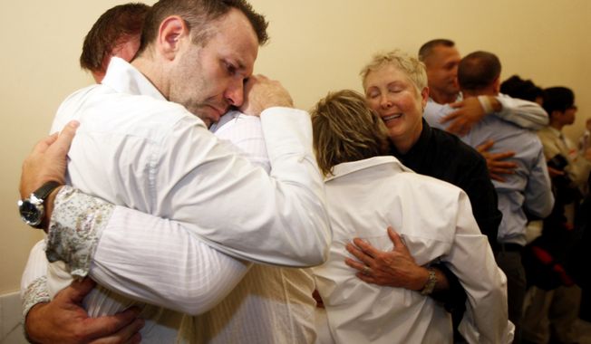 Same-sex couple Robert Huddleston, left, and Chris Holler, second from left, of San Francisco, react to the news that they may not marry for at least another week Thursday, Aug. 12, 2010, in San Francisco. A federal judge put gay marriages on hold for at least another six days in California, disappointing dozens of gay couples who lined up outside City Hall hoping to tie the knot Thursday. Judge Vaughn Walker gave opponents of same-sex weddings until Aug. 18 at 5 p.m. to get a ruling from the 9th U.S. Circuit Court of Appeals on whether gay marriage should resume. Gay marriages could happen at that point or be put off indefinitely depending on how the court rules.(AP Photo/Eric Risberg)