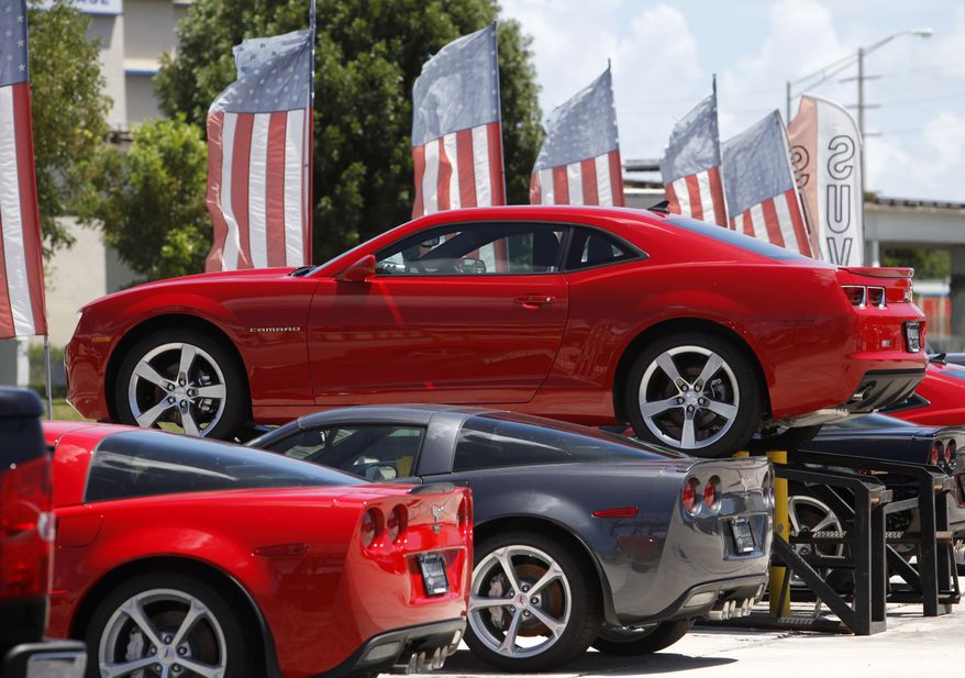 A 2010 Chevrolet Camaro RS is on display above a row of 2010 Corvettes at Kendall Chevrolet in Miami on Thursday, Aug. 5, 2010. (AP Photo/Lynne Sladky)