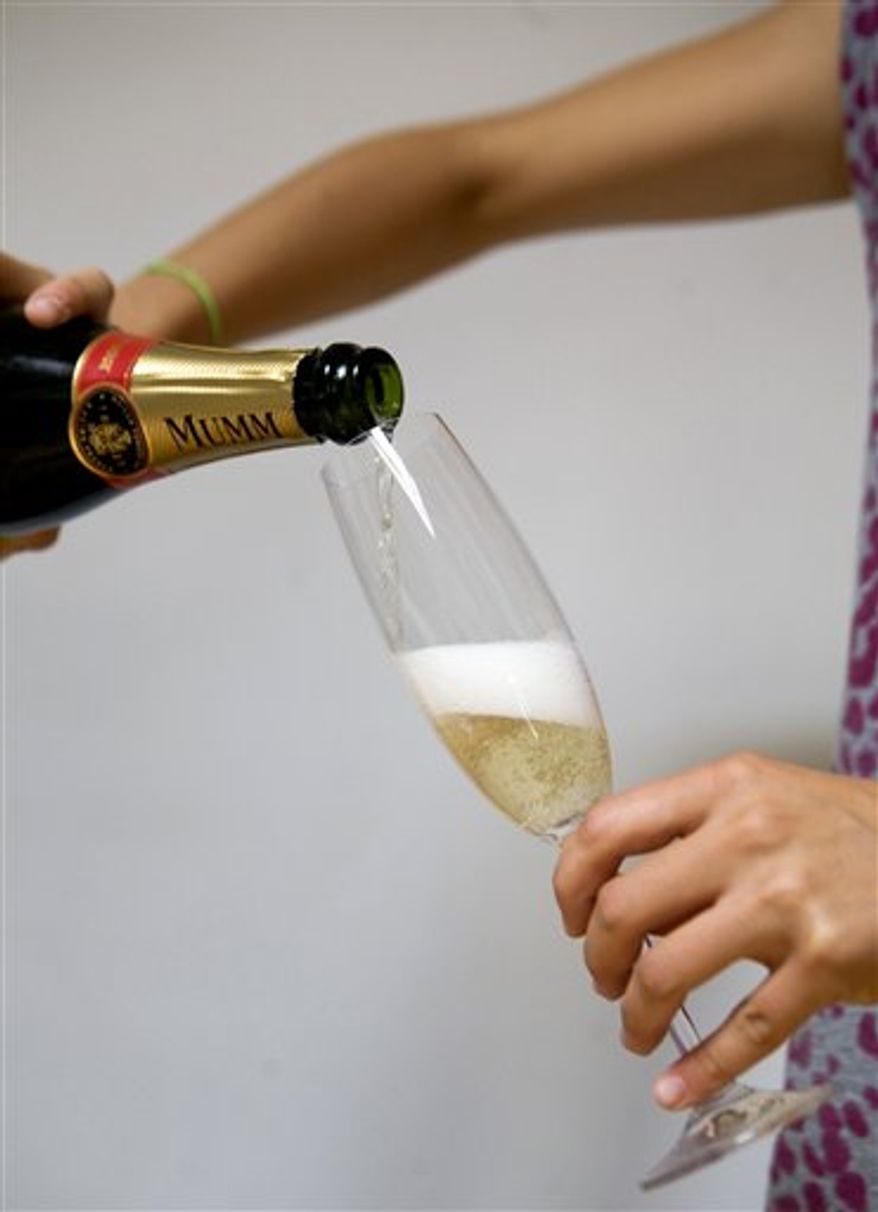 View of two flutes of Champagne, the one at left having being filled straight down into the flute, and the one at right having being filled the "beer-like way," Thursday Aug. 12, 2010 in Paris, to illustrate a theory by French scientist from Reims university. French scientists at the University of Reims in the home of Champagne have determined that pouring bubbly on a slant like you would a beer is actually a better way to serve Champagne because it preserves more of the tiny gas bubbles that improve the drink's flavor and aromas.(Ap Photo/Jacques Brinon)