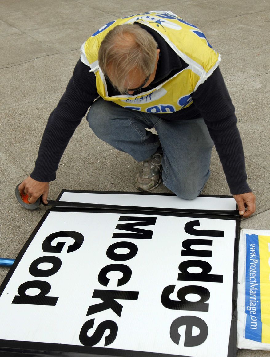 A man who identified himself as Richard prepares a sign in opposition to gay marriage on Thursday, Aug. 12, 2010, outside City Hall in San Francisco. Judge Vaughn Walker gave opponents of same-sex weddings until Aug. 18 at 5 p.m. to get a ruling from the 9th U.S. Circuit Court of Appeals on whether gay marriage should resume. (AP Photo/Ben Margot)