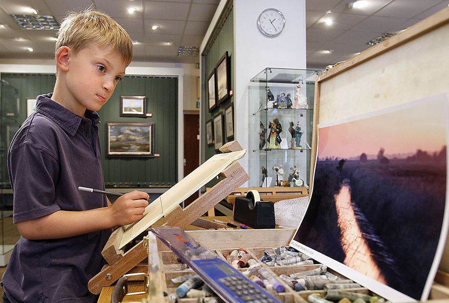 In this Thursday, Aug. 12, 2010 photo Kieron Williamson, an eight-year-old painting prodigy is seen working on a drawing in Holt, Norfolk in England. He's Britain's most talked-about young artist. His paintings sell for thousands of dollars and there's a long waiting list for his eagerly anticipated new works. (AP Photo/Kirsty Wigglesworth)