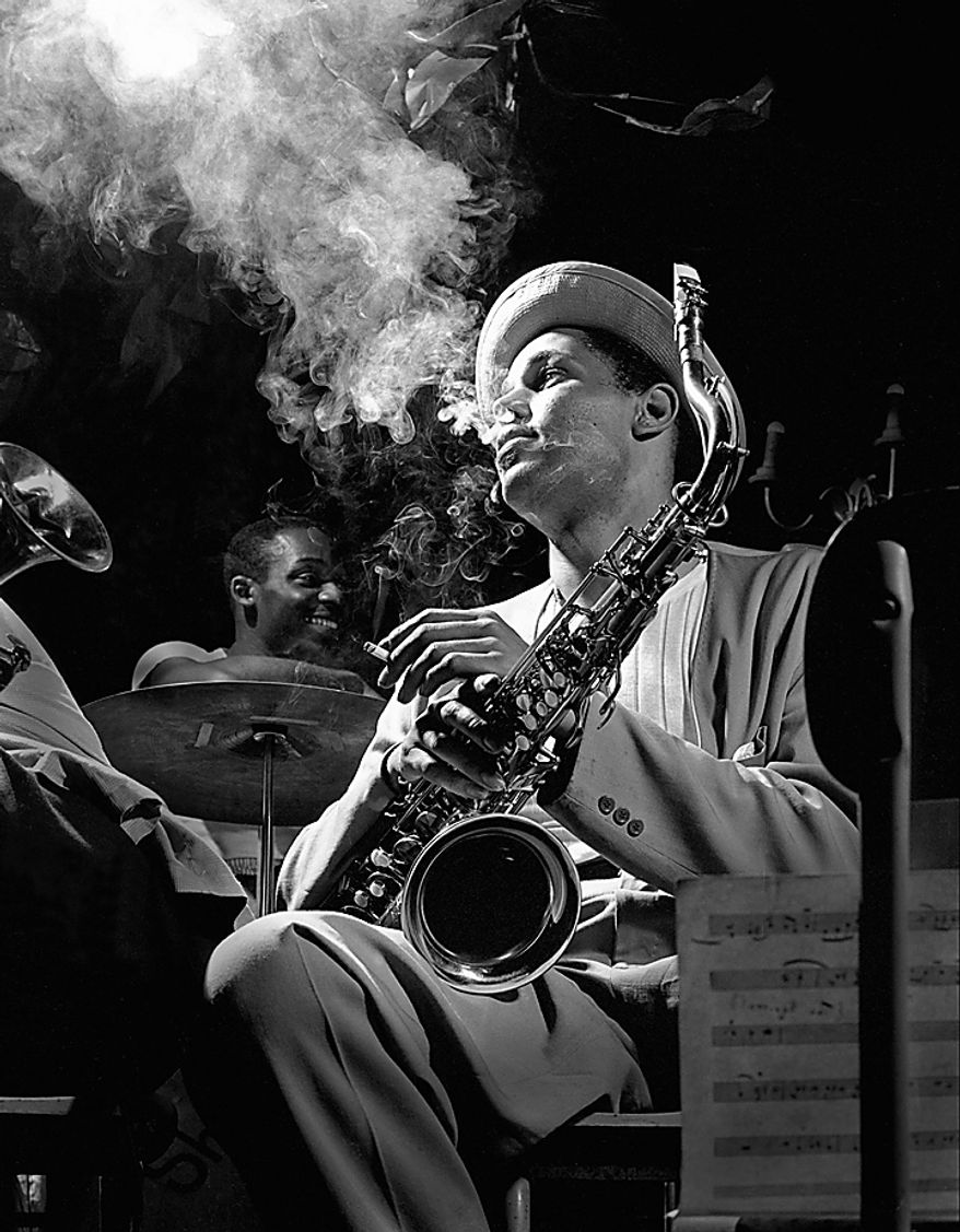 This 1948 file photo released by Herman Leonard Photography, shows tenor saxophonist Dexter Gordon photographed by Herman Leonard, with Gordon enveloped in his cigarette smoke at the Royal Roost in New York. Mr. Leonard, famous for his smoky, backlighted black-and-white photos of such greats as Billie Holiday, Duke Ellington, Charlie Parker, Louis Armstrong, Miles Davis and Frank Sinatra, died Saturday, Aug. 14, 2010, at Cedars-Sinai Medical Center in Los Angeles, family spokeswoman Geraldine Baum said. He was 87. (AP Photo/Herman Leonard Photography, LLC., CTSIMAGES, File)