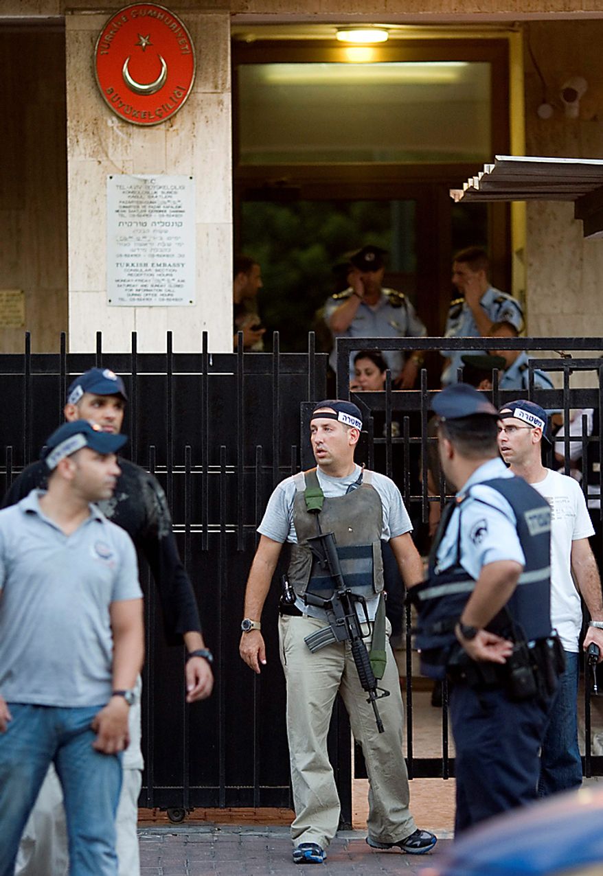 Israeli police officers are seen in front of the Turkish Embassy in Tel Aviv, Israel, Tuesday, Aug. 17, 2010. A Palestinian took hostages in the Turkish Embassy in Tel Aviv Tuesday after shots were fired outside, Israeli police and a Foreign Ministry official said, in an incident that appeared to have only an indirect link to recent tensions between the two countries. (AP Photo/Ariel Schalit)