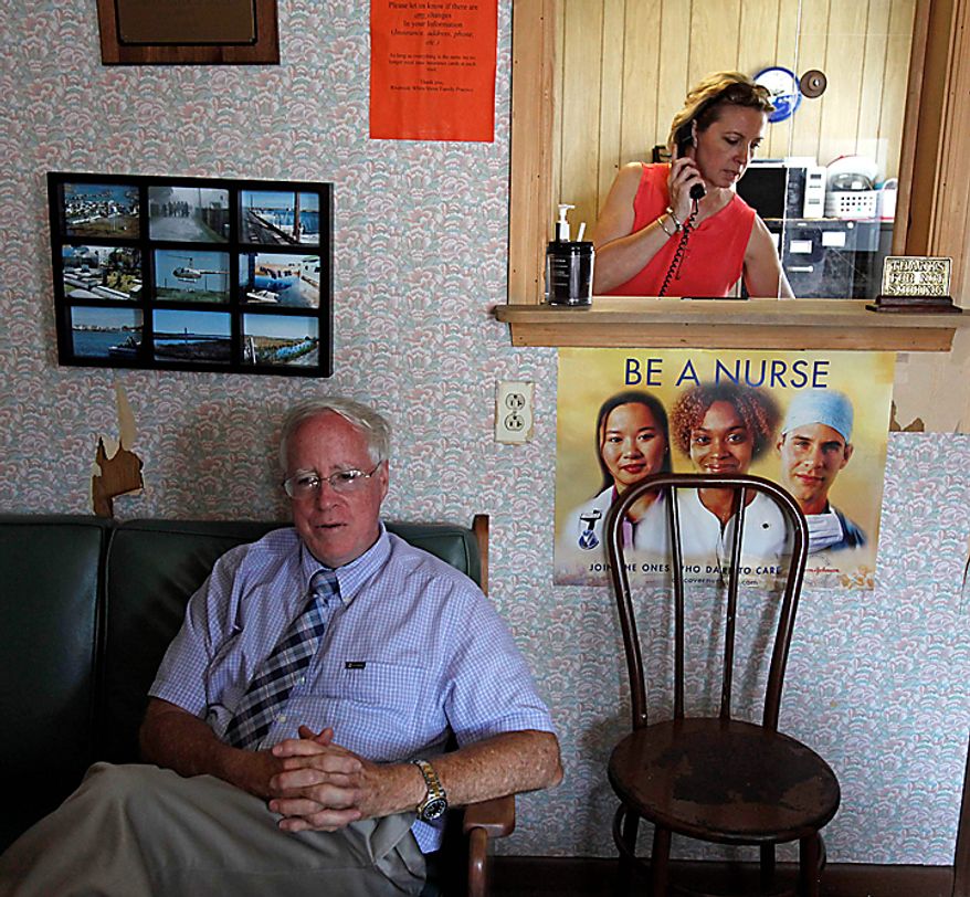 Physician's Assistant Inez Pruitt, right, takes a call as Dr. David Nichols relaxes inside the old health clinic on Tangier Island, Va., Monday, Aug. 9, 2010. The brand new Tangier Island Health Clinic is scheduled to open Aug. 29. Dr. Nichols, who has been flying to Tangier to care for the residents for 30 years, has been diagnosed with terminal cancer. (AP Photo/Richmond Times-Dispatch, Bob Brown)