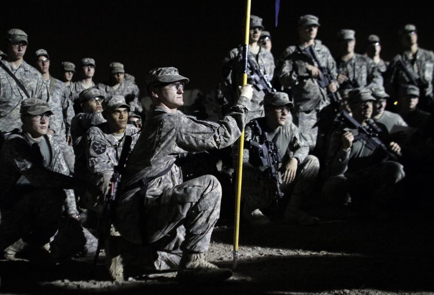 U.S. Army soldiers from C Co., 4th Battalion, 9th Infantry Regiment, 2nd Infantry Division gather Saturday for a formation before driving from Iraq to Kuwait. The soldiers are the last combat brigade to leave Iraq as part of the drawdown of U.S. forces. (Associated Press)