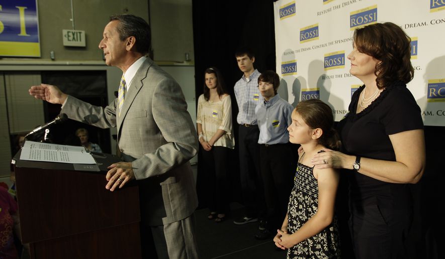 Republican senatorial candidate Dino Rossi talks to supporters and reporters as his wife, Terry (right), and their children, (from second from left) Juliauna, Jake, Joseph and Jillian, look on, on Tuesday, Aug. 17, 2010, in Bellevue, Wash., on Washington state&#39;s primary election day. (AP Photo/Ted S. Warren)