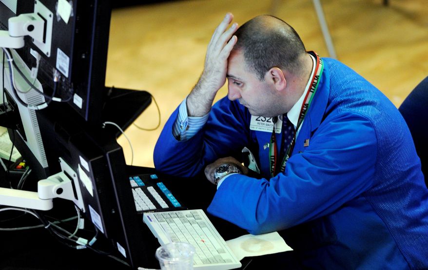 ASSOCIATED PRESS
WAITING FOR GOOD NEWS: Banc of America specialist Peter Giacchi reacts to the numbers on his computer screen on the floor of the New York Stock Exchange on Thursday.