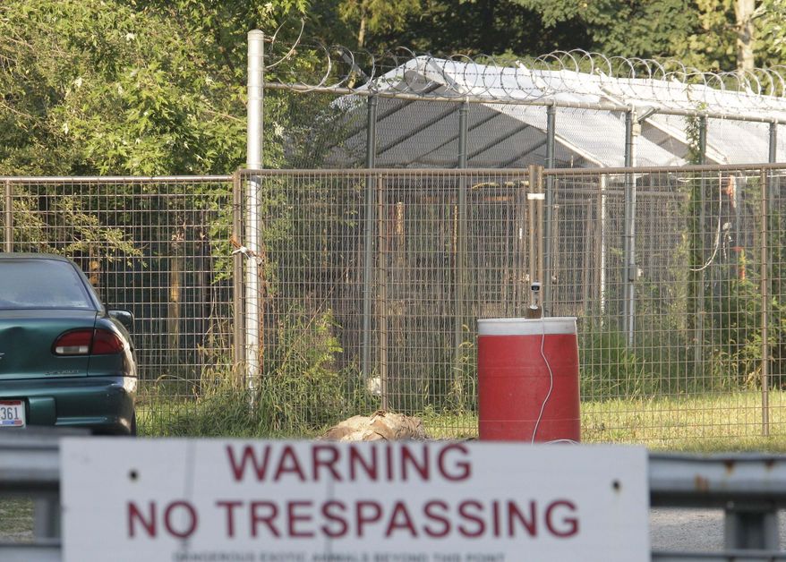 Razor wire tops an enclosure at an exotic animal farm Friday, Aug. 20, 2010, in Columbia Station, Ohio, where a 24-year-old man was severely injured by a bear Thursday night. The sheriff's office says the bear is owned by Sam Mazzola, who at one time offered people the chance to wrestle a black bear at a Cleveland expo. (AP Photo/Mark Duncan)
