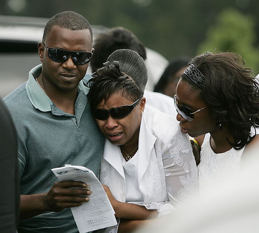 Family members console each other after leaving the funeral service of Devean Duley,2 and Ja'van Tyrell Duley, 18 month, Friday, Aug. 20, 2010, at St. Paul Baptist Church in Orangeburg, S.C. The boys' 29-year-old mother, Shaquan Duley, was not allowed to attend. Investigators say she confessed to smothering her children Sunday night then staging a car accident to cover up the deaths. (AP Photo/Mary Ann Chastain)