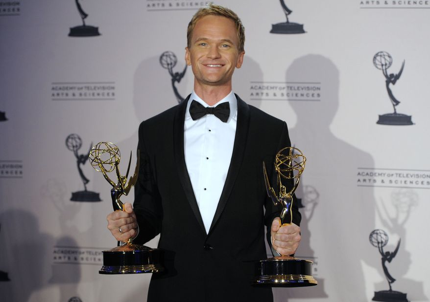 Neil Patrick Harris poses with the Emmys he won as oustanding guest actor in a comedy series for "Glee" and for oustanding special-class programs as the host at the 63rd annual Tony Awards at the Creative Arts Emmy Awards on Saturday, Aug. 21, 2010, in Los Angeles. (AP Photo/Chris Pizzello)