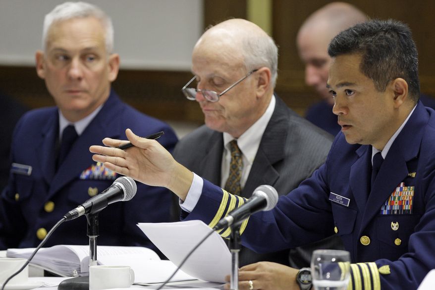 U.S. Coast Guard Capt. Hung Nguyen (right), co-chair of the hearings being conducted jointly by the Coast Guard and the Interior Department's Bureau of Ocean Management, Regulation and Enforcement, asks a question as U.S. Coast Guard Capt. Mark Higgins (left) and Wayne Andersen (center), a retired U.S. District Court judge, listen on Monday, Aug. 23, 2010, in Houston. (AP Photo/Melissa Phillip, Pool)