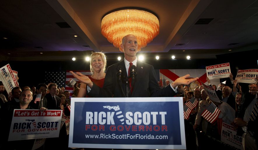 Republican gubernatorial candidate Rick Scott (center) gestures as he speaks with supporters on Tuesday, Aug. 24, 2010, in Fort Lauderdale, Fla. At left is Mr. Scott&#39;s wife, Ann. Florida&#39;s GOP voters chose the wealthy Mr. Scott, a political newcomer, over career public servant Bill McCollum as their candidate for governor. (AP Photo)