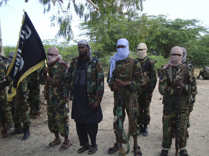 Hard-line Islamist Al-Shabab fighters conduct military exercises in northern Mogadishu's Suqaholaha neighborhood in Somalia Monday Aug. 23, 2010. The group's senior officials said the young fighters have recently completed training to join what they said to be a global war against the enemy of Allah. (AP Photo/ Farah Abdi Warsameh)