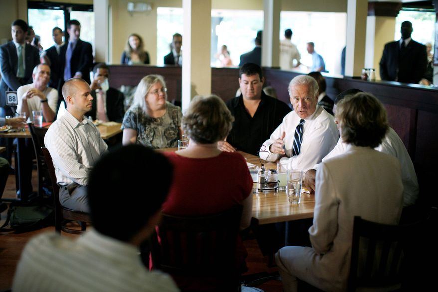 ASSOCIATED PRESS
Vice President Joseph R. Biden Jr. (seated at right) talks about the economy with local workers and small-business owners Wednesday at Pete's New Haven Style Apizza restaurant in Washington.