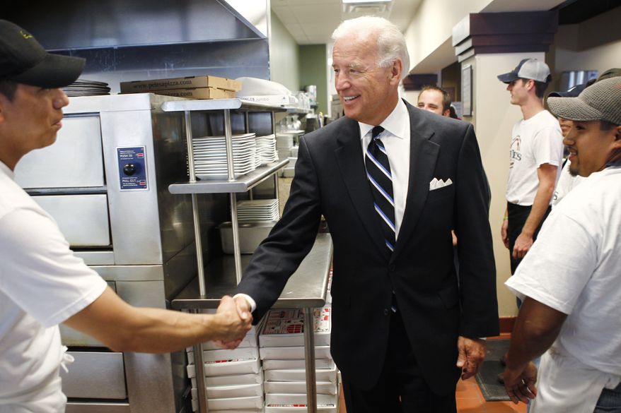 Vice President Joseph R. Biden Jr. greets workers at Pete's New Haven Style Apizza restaurant in Washington on Wednesday, Aug. 25, 2010, before holding a discussion about the economy. (AP Photo/Charles Dharapak)