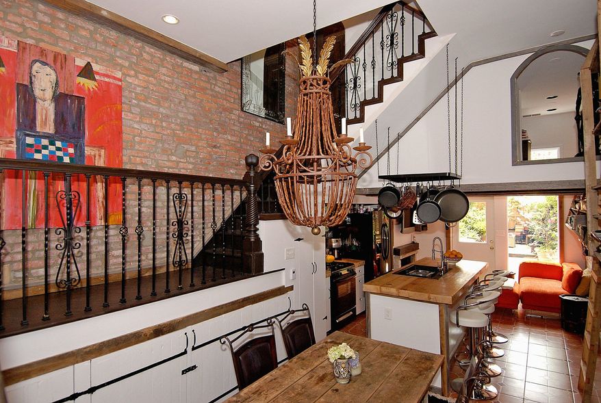 The renovated country kitchen is on the home's lower level, which is the main living level. Beyond the kitchen is the cozy family room, which features a wood-burning fireplace.