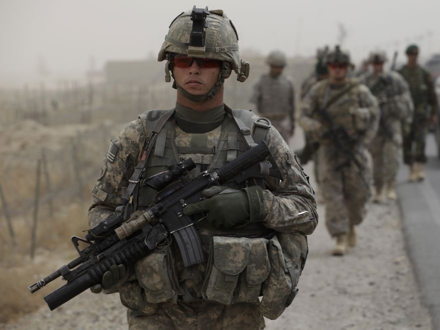 U.S. Army Spc. David Zink, of Leavenworth, Kan., of Tactical Command Post, HQ Company, 2-502 Infantry, 101st Airborne Division, walks with platoon-mates during a joint patrol with the Afghan Army, in Zhari district, Kandahar province, southern Afghanistan, Wednesday Aug. 25, 2010. Soldiers in Zhari operate in a district which is the birthplace of the Taliban movement, and holds many well-armed insurgents who blend in with a support network providing them with explosives and safe havens. (AP Photo/Brennan Linsley)