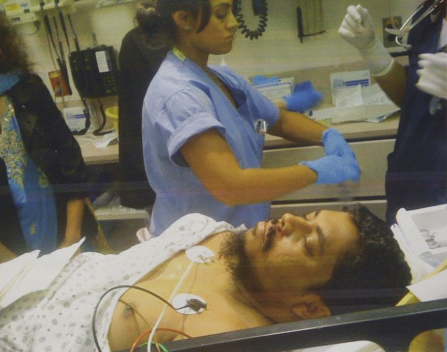 This undated photograph provided by the New York Taxi Workers Alliance shows taxi driver Ahmed H. Sharif in a hospital in New York. A drunken passenger riding in a New York City taxi cab attacked the driver after asking him if he was Muslim, police said. Mr. Sharif was treated for cuts to the throat, upper lip, forearm and thumb. (AP Photo/New York Taxi Workers Alliance)