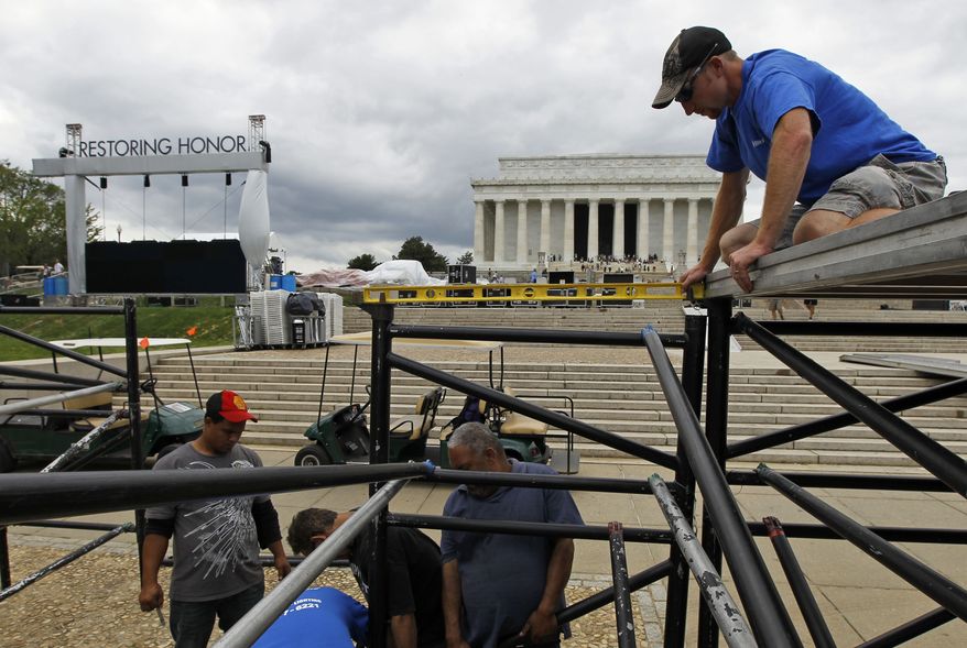 Ryan Palmer (right) with Elite Productions uses a level as the stage is being constructed on Wednesday, Aug. 25, 2010, for the Glenn Beck "Restoring Honor" rally in front of the Lincoln Memorial in Washington. Mr. Beck's rally on the anniversary and at the site of Martin Luther King Jr.'s famous "I Have a Dream" speech is drawing criticism, protests and questions about his intentions. (AP Photo/Alex Brandon)