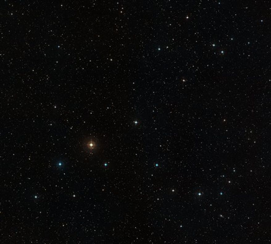 This photo made available by the European Southern Observatory Tuesday, Aug. 24, 2010, shows a close-up of the sky around the star HD 10180. The picture was created from photographs taken through red and blue filters and forming part of the Digitized Sky Survey 2. The field of view is approximately eleven arcminutes across. The blue and orange halos around the star, and the eight spikes of light, are artifacts of the imaging process and are not real. The remarkable planetary system around this star is far too faint and close in to be visible in this image. (AP Photo/ESO, Davide De Martin)