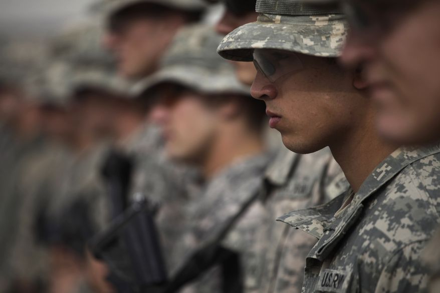 American soldiers of the 2-502 Infantry, 101st Airborne Division, participate in a memorial service for an Afghan Army officer from a partner unit who was killed in an insurgent ambush a day earlier, at Forward Operating Base Howz-e-Madad, in Zhari district, Kandahar province, southern Afghanistan, Friday Aug. 27, 2010. American soldiers, and their Afghan partners in Zhari, operate in a district which as the birthplace of the Taliban movement holds many well-armed insurgents who blend in with an organized support network providing explosives and safe haven. (AP Photo/Brennan Linsley)
