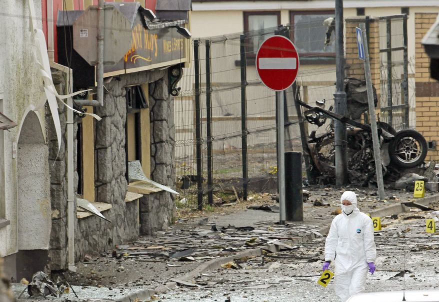 Wreckage is scattered across a street in Armagh, Northern Ireland, after a car bombing outside a police station in April, as tensions between Catholics and Protestants increased. (Associated Press)