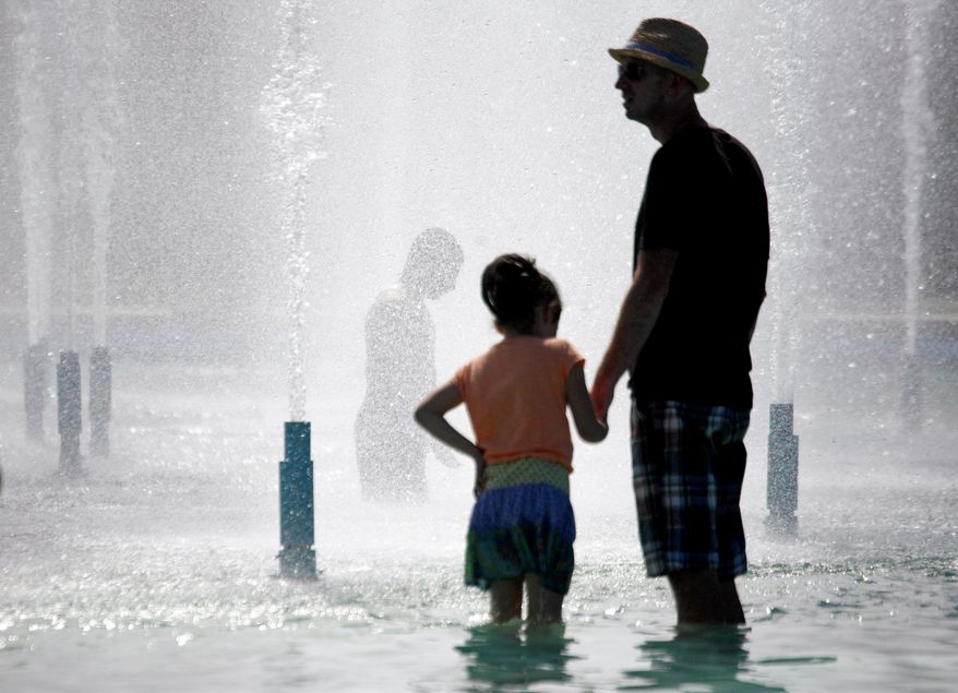 Children and adults alike cool off Sunday in a Flushing Meadows fountain in the borough of Queens in New York City. The temperature reached the 90s in the city. In the normally temperate region, the remaining days of August are forecast to be hot with readings around 90 in many areas of the Mid-Atlantic and Northeast. (Associated Press)