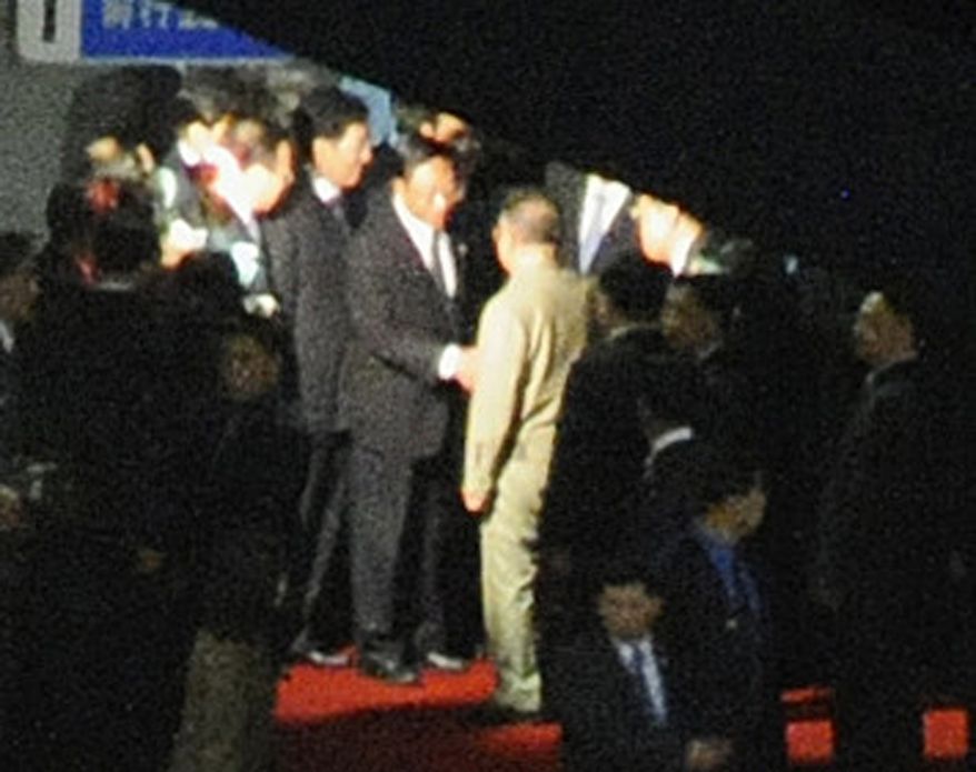 A man believed to be North Korean leader Kim Jong-il (center, facing away from camera, is greeted at Changchun rail station in Changchun, China, on Saturday, Aug. 28, 2010. Mr. Kim reportedly has met top Chinese leaders in an apparent bid for Beijing's diplomatic and financial support for a succession plan involving his third and youngest son, who is said to be traveling with him. (AP Photo/Kyodo News Agency)