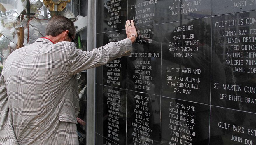 The Katrina Memorial Wall on the Town Green in downtown Biloxi, Miss., has special significance to Harrison County Coroner Gary Hargrove, shown following the fifth annual Hurricane Katrina memorial observance on Sunday, Aug. 29, 2010. His office handled 156 of the 170 persons whose names are etched in the wall. (AP Photo/Rogelio V. Solis)