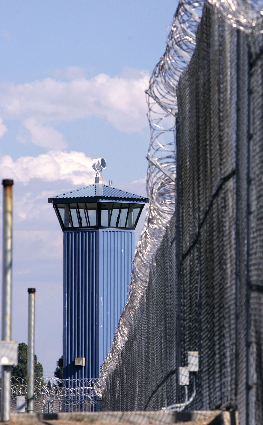 **FILE** A guard tower is seen behind the wire fence that surrounds California's Folsom State Prison, about 20 miles outside Sacramento. (Associated Press)