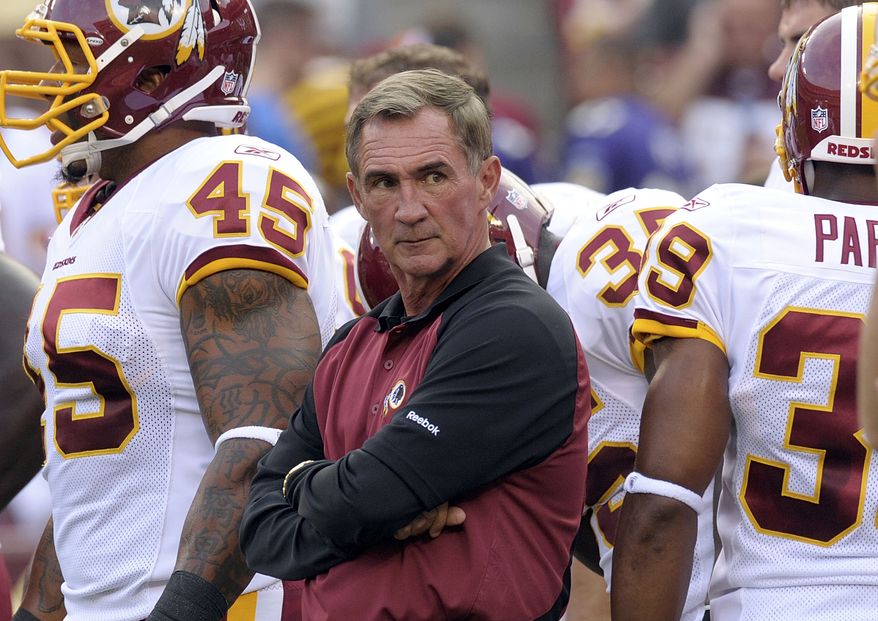 ASSOCIATED PRESS FILE - In this Aug. 21, 2010, file photo, Washington Redskins head coach Mike Shanahan watches warm ups before a preseason NFL football game against Baltimore Ravens in Landover, Md. 