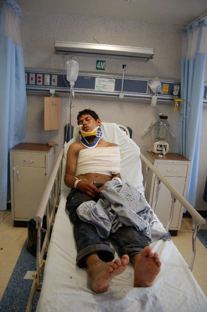 Luis Fredy Lala Pomavilla, an Ecuadorean citizen who survived a massacre that left 72 Central and South American migrants dead at a ranch 100 miles south of the U.S.-Mexican border, rests at a hospital in Matamoros on Aug. 24. He said the killers said they belonged to the Zetas drug cartel. (Associated Press)